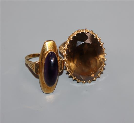 A smoky quartz and 9ct gold dress ring with fancy setting and a yellow metal ring with oval cabochon amethyst